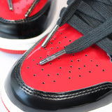 Looped Laces Black waxed shoelaces in Air Jordan 1 High Patent Bred sneakers with close up on metal aglet with LL logo