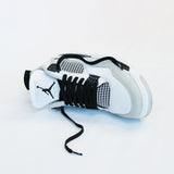 Looped Laces Noir black flat shoelaces in Air Jordan 4 Military Black sneaker on white background with close up on laces