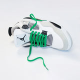 Looped Laces Pine Green flat shoelaces in Air Jordan 4 Military Black sneaker on white background with close up on laces