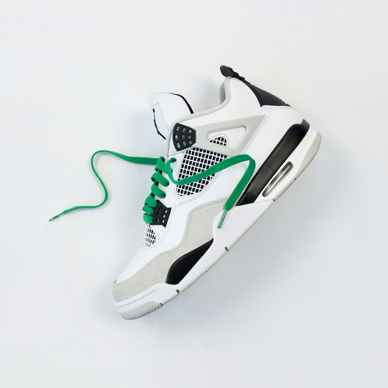 Looped Laces Pine Green flat shoelaces in Air Jordan 4 Military Black sneaker on white background