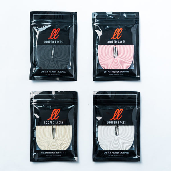 Looped Laces Waxed shoelaces in colors: black, light pink, cream and white in packaging on white background