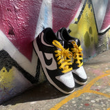 Looped Laces Starlight flat shoelaces tied in Nike Panda Dunks against a graffiti wall