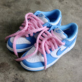 Looped Laces Light Pink Jumbo Rope Shoelaces tied in a pair of Nike Dunk UNC Blue sneakers on cement