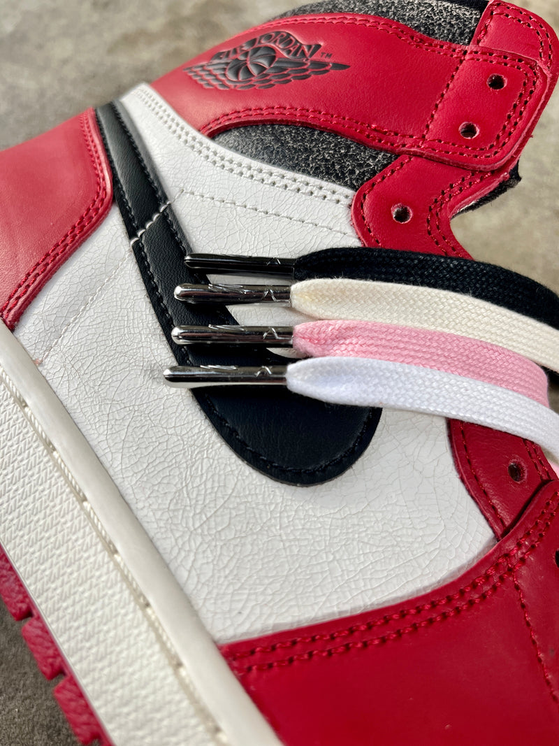Looped Laces Waxed Shoelaces in colors: black, cream, light pink and white on top of Air Jordan 1 High Chicago Lost and Found sneaker
