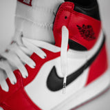 Looped Laces OG White flat shoelaces in Air Jordan 1 Chicago sneaker with close up on lace tips - aglets