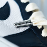 Looped Laces Cream Waxed shoelaces in Air Jordan 1 High Atmosphere Bubblegum sneaker close up on logo embossed metal aglets
