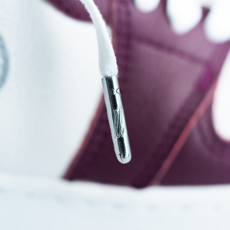 Looped Laces White waxed shoelaces in Air Jordan 1 High Bordeaux sneakers with close up on logo embossed metal aglet - lace tip